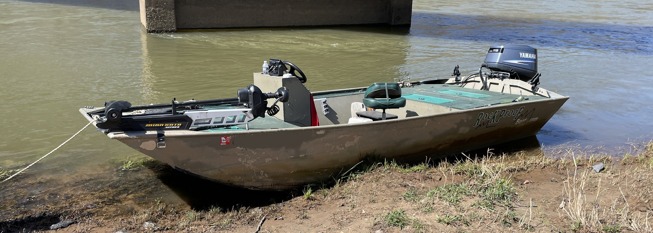 Rockproof outboard jet boat resting at the river's edge